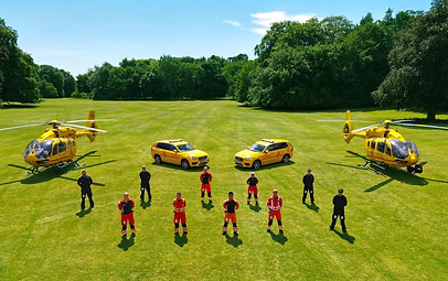 Eaaa team cars and helis in field.jpg