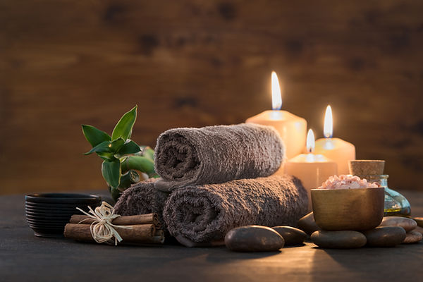 Brown towels with bamboo and candles for