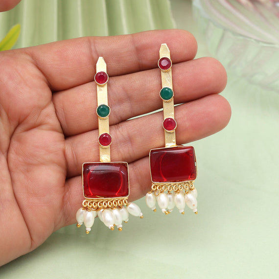 Elegant red earrings with green accents and pearls
