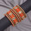 Thumbnail: Orange velvet bangles with gold accents