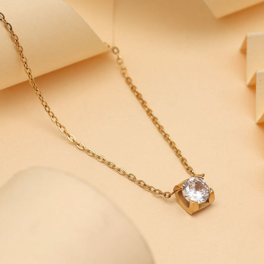Elegant gold necklace with single clear stone pendant