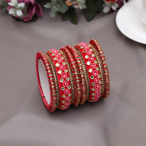 Red jeweled bangles with pearl accents