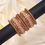 Thumbnail: Orange and gold bangles with white stones