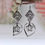 Thumbnail: Elegant silver floral earrings with star detail