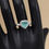 Thumbnail: Heart-shaped ring with blue gemstone and diamond halo