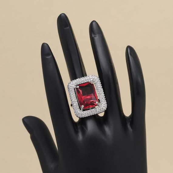 Red gemstone ring with diamond accents