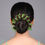 Thumbnail: Woman's bun adorned with dark-red and green floral hair accessory