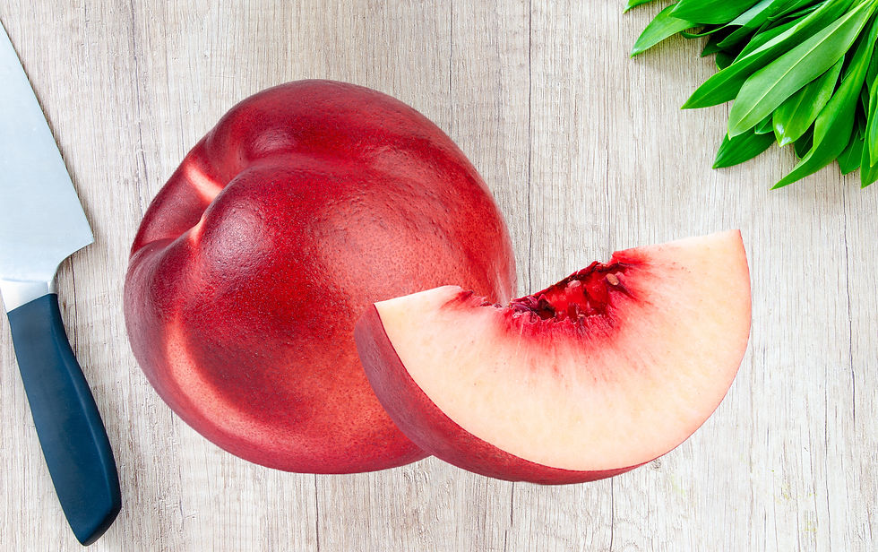 Whole and quarter nectarine on bench with knife.