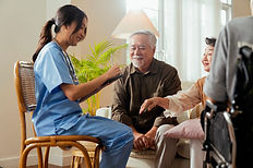 happiness-cheerful-elderly-woman-men-talking-with-female-caregiver-nurse-doctor-having-health-checking-consult-living-areacaretakers-with-senior-couple-sitting-living-room-nursing-home