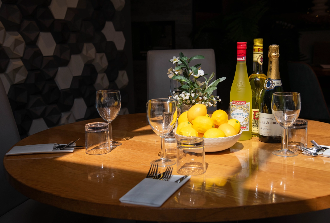 A table set for Bottomless Brunch with limoncello, prosecco and lemons
