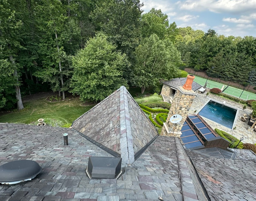 Roofer locating a hidden leak entry point on a New Jersey roof