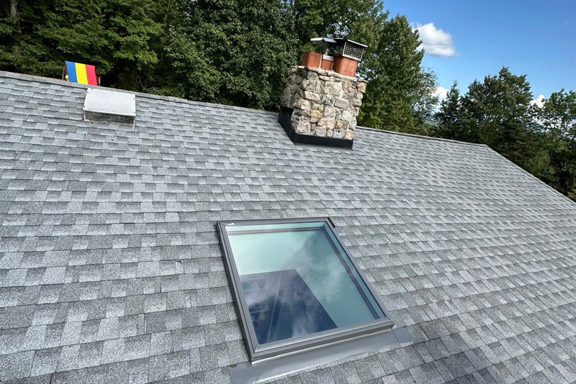 Mason repointing chimney mortar joints on a Nutley NJ home