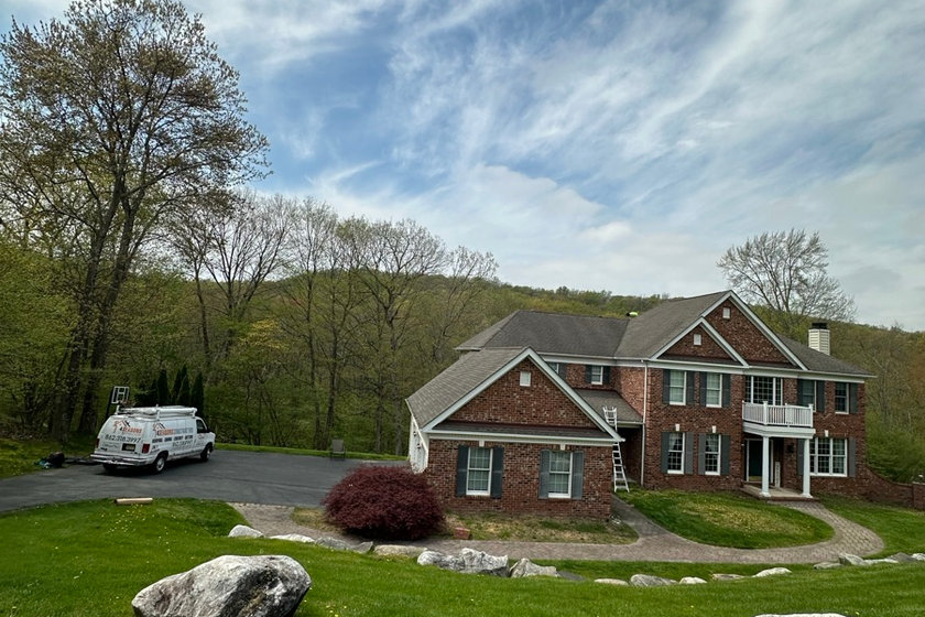 Inspecting siding material and trim detail on a North Jersey home