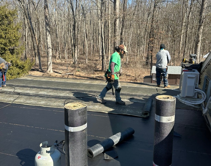 Flat roof repair underway on a North Jersey multi-family home