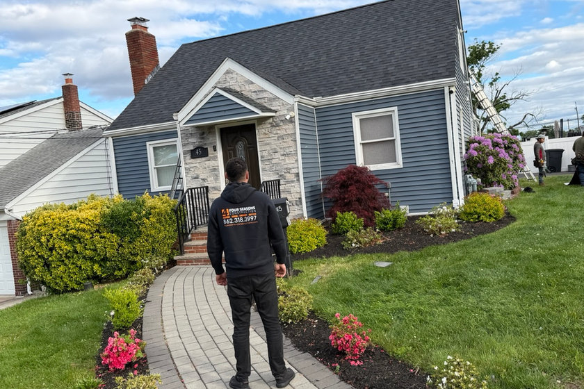 Masonry crew repairing a brick chimney near Little Falls, NJ