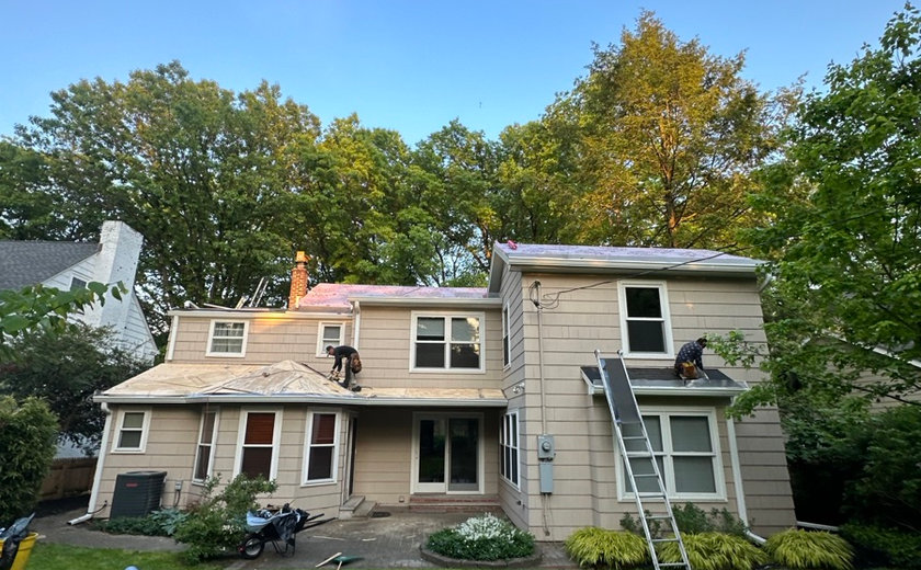 Four Seasons Roofing and Construction crew installing an emergency roof tarp for a Union NJ home