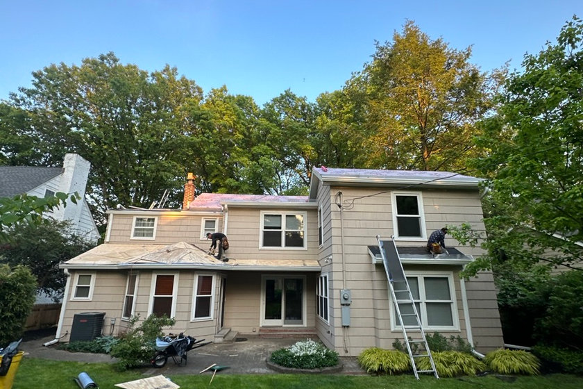 Wind-lifted ridge and rake edge on a Garfield NJ roof after a nor'easter