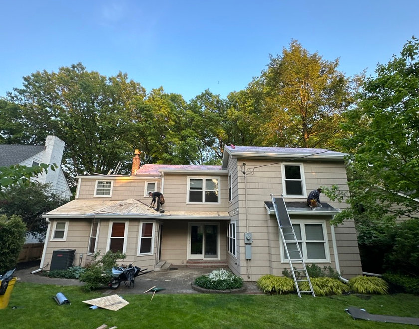 Emergency crew clearing and sealing a leaking roof in North Jersey
