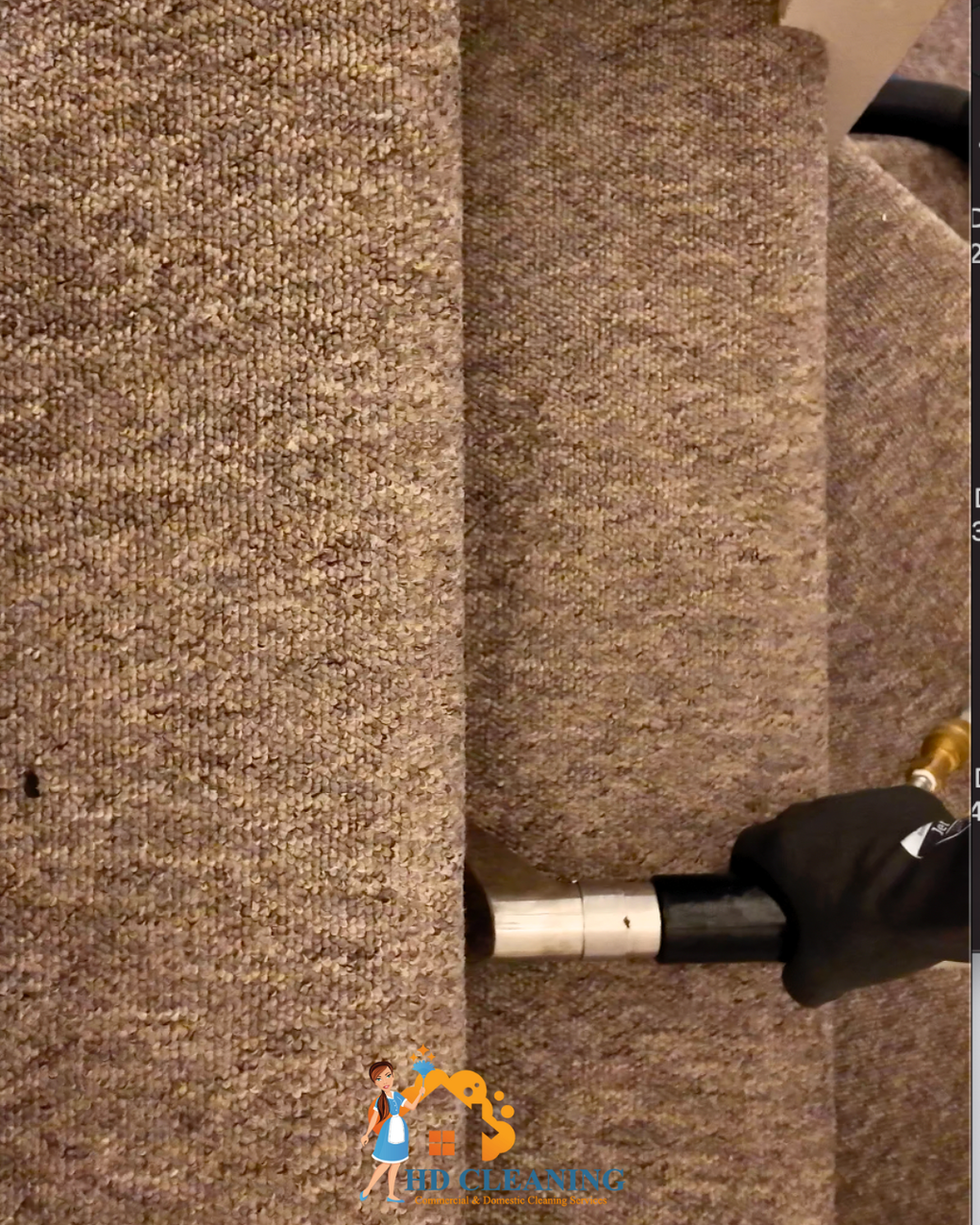 Close up hot water extraction on stair carpet removing dirt in Clapham