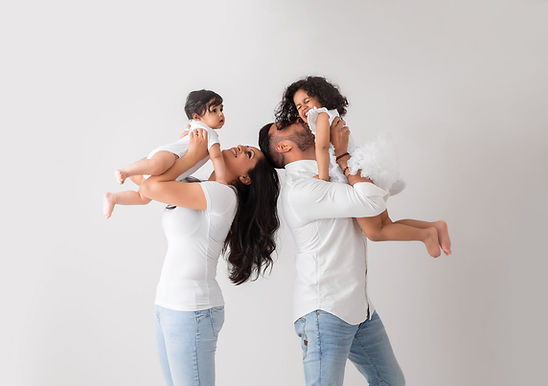 siblings with parents during family photoshoot