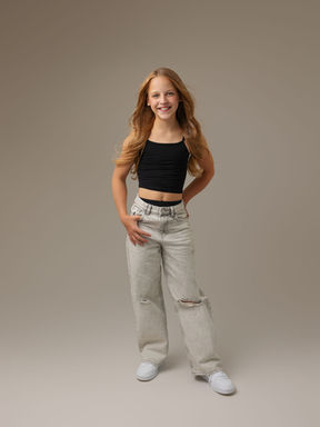 Teen girl standing confidently during a studio portrait