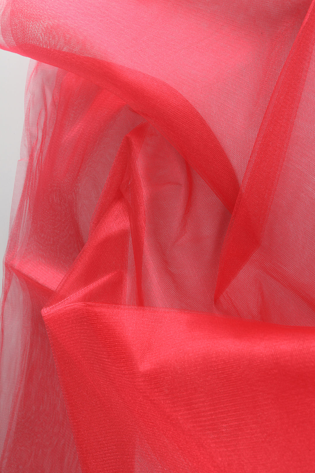 Close-up of bright, high-shine tutu tulle fabric, showcasing stiff weave and sparkling texture.