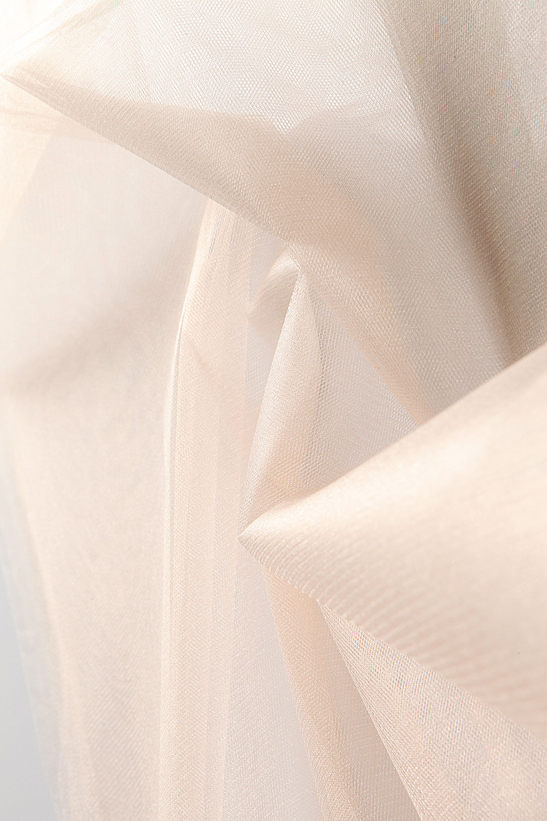 Close-up of bright, high-shine tutu tulle fabric, showcasing stiff weave and sparkling texture.