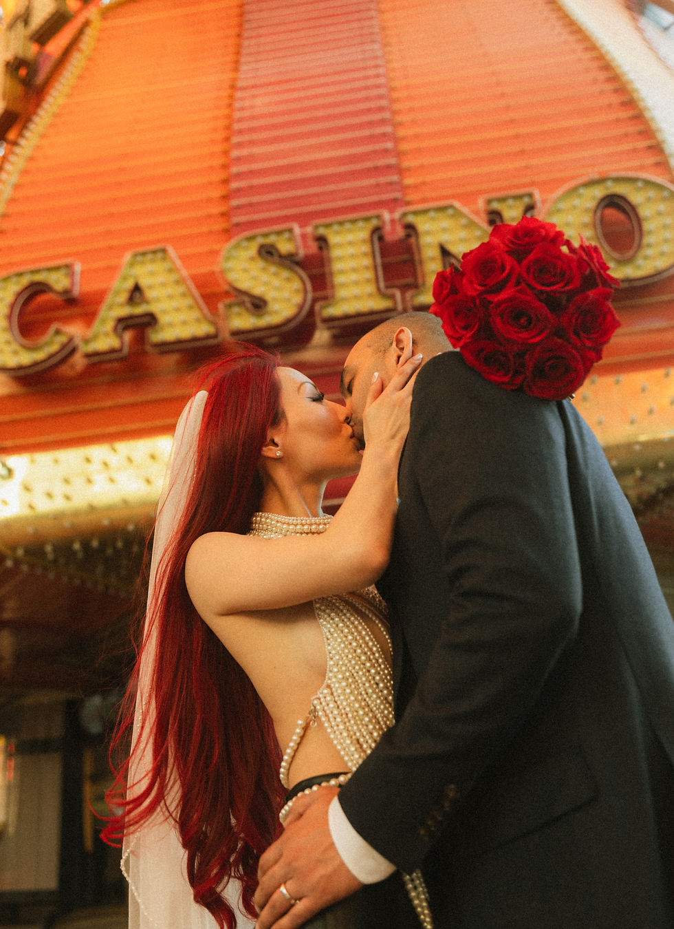 Couple kissing on Fremont Street in Las Vegas after their elopement ceremony.