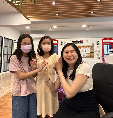 2 girl students holding hands with a female teacher