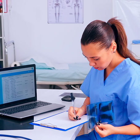 nurse-checking-x-ray-result-reading-patients-list-taking-notes-clipboard-holding-radiograp