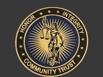 The Clearwater Police Challenge Coin features a radiant depiction of Lady Justice in vibrant gold, set against a rich, deep blue background.