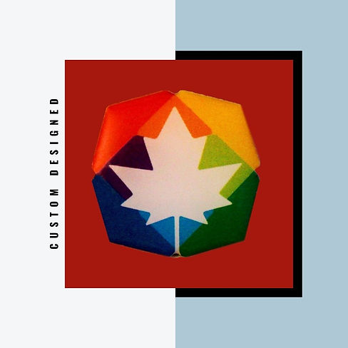 Custom shaped lapel pin with white maple leaf on multicoloured background.