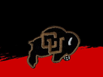 A mini embroidered patch featuring a bison stitched in black and gold thread.