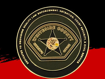 A round sheriff challenge coin featuring a gold star on a dark green background.