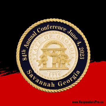 A round, commemorative coin with bright gold justice insignia, on a white and dark blue background.