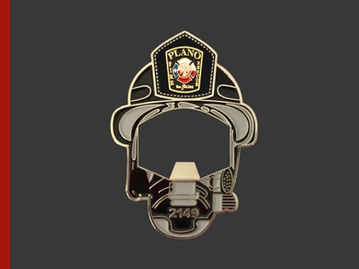Plano Fire Department Challenge coin bottle opener shaped as Firefighter helmet with Maltese Cross.