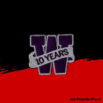 A small, deep purple, embroidered patch with contrasting grey details.