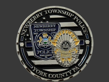 Newberry TWP Police Challenge Coin with badge and shield in golds, blacks, whites on black and silver lines