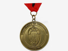 Antique gold Wisconsin University medal with logo and text.