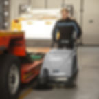A Mach 1 walk behind sweeper in use