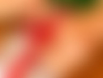 A hand tying a cross-over ribbon bow