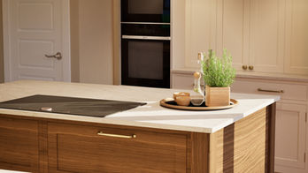 Kitchen design in shaker style, off-white with a wood island. Designed in Unreal Engine for viewing in VR