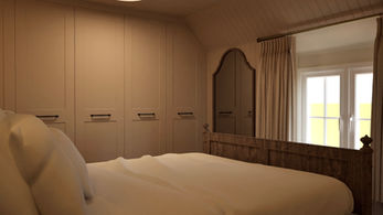Master bedroom design with fitted wardrobes and traditional cottage styling.