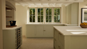 Open-plan kitchen with central island and family living area beyond