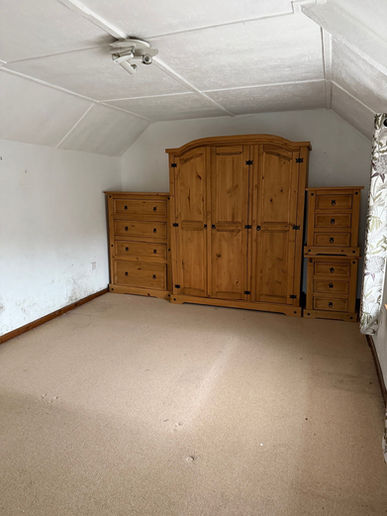 Existing bedroom within countryside cottage prior to renovation and redesign.