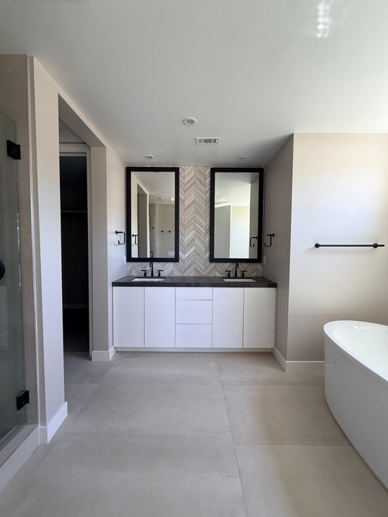 Vanity with chevron tile — White cabinets. Black fixtures. Chevron tile doing its best.
