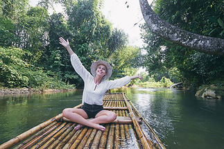 Traveling by Thailand. Pretty young woman enjoying view sailing jungle river on traditiona