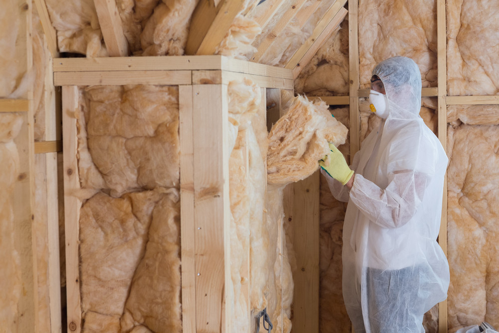 Worker putting in insulation