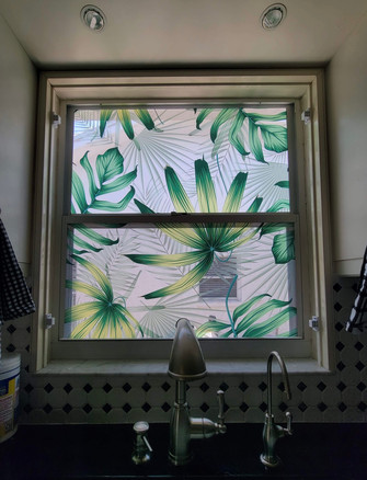 Kitchen window with custom decorative film with colored foliage and clear background. Customer had selected foliage, position and direction.