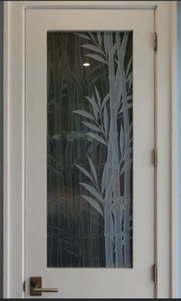 Custom Entry door design with two tones of bamboos to create the appearance of depth.